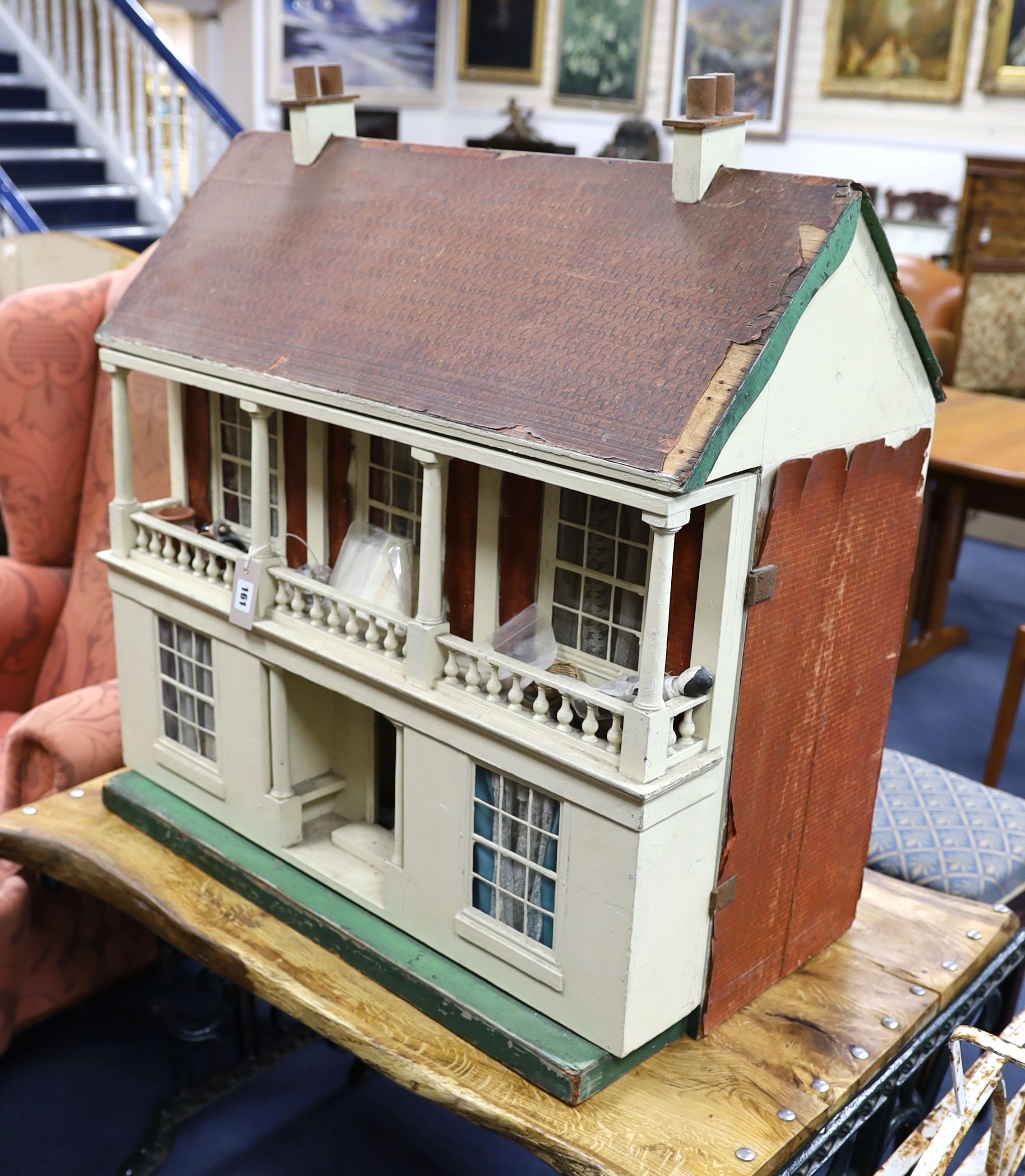 An early 20th century painted dolls house with accessories, width 82cm, height 84cm